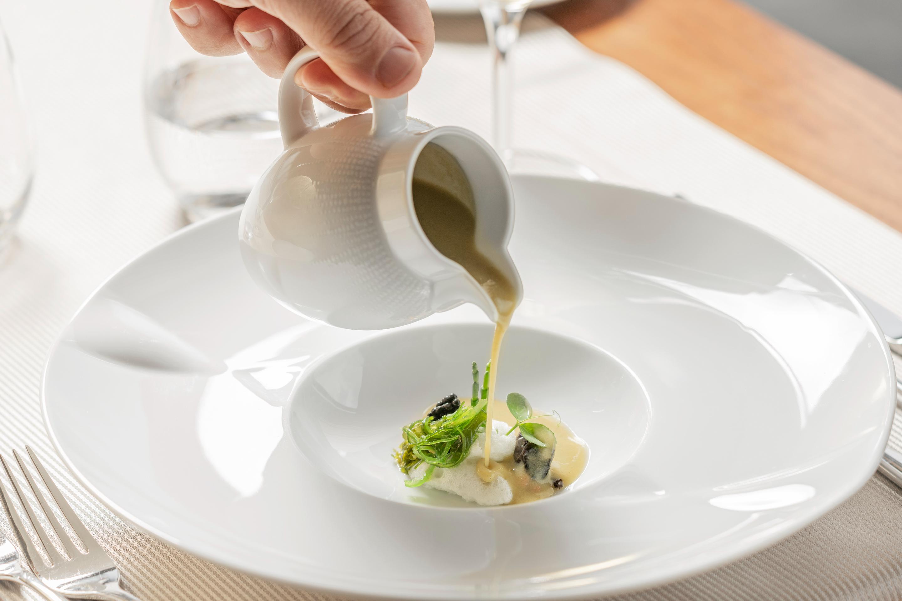 Grand Hotel Acores Atlantico Понта Делгада Екстериор снимка A sauce being poured onto a plate of food